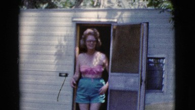 1964: Pretty Woman in Pink Bra and Blue Shorts Emerges from Cabin