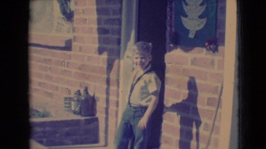 1968: funny boy circles around a pole on the veranda of the house CLARKSDALE