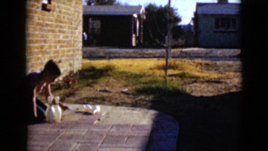1968: group of boys setting up bowling pins to play outside in the summer