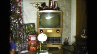 1968: a christmas tree is seen with a child opening presents CLARKSDALE, ARIZONA