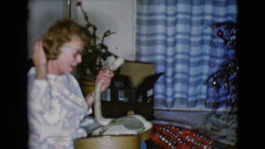 1968: a christmas tree is seen with a child opening presents CLARKSDALE, ARIZONA