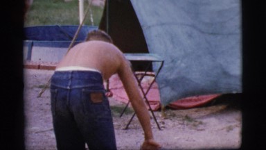 1968: a topless kid is seen pouring in a pot COTTONWOOD, ARIZONA