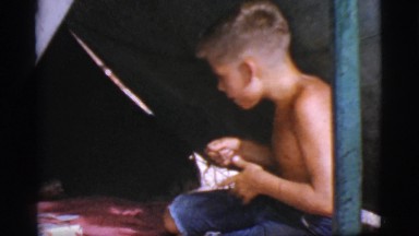 1968: a topless kid is seen pouring in a pot COTTONWOOD, ARIZONA