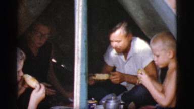 1968: family eating corn food in tent camping COTTONWOOD, ARIZONA