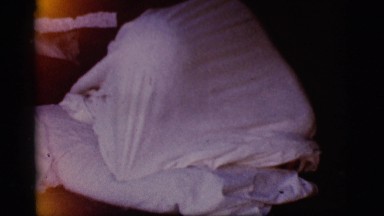 1968: baby under white sheet moving around playing games COTTONWOOD, ARIZONA