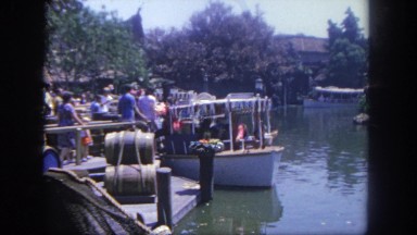 1962: people on and around a small boat as they wait their turn to go on board.