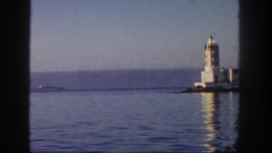 1962: boat traveling at high speed takes passengers past a lighthouse SAN PEDRO