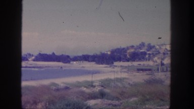 1962: a beautiful view of the ocean coastline and beach with waves crashing
