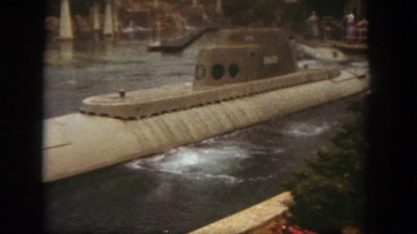 1962: people standing at the bay to watch submarines passing through the water