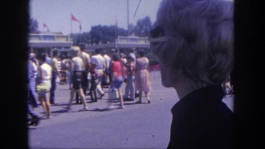 1962: various people entering and exiting a large amusement park DISNEYLAND