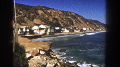 1962: a housing community hugs the shore between the mountains and the ocean.
