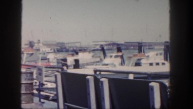 1962: harbor full of boats and vessels remain anchored along the shore