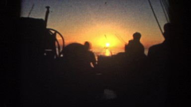 1962: men on a boat fishing as the sun sets on the horizon DISNEYLAND