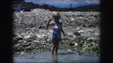 1958: a small boy is crossing a river AMES, IOWA