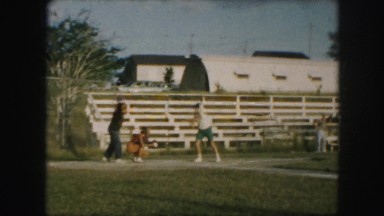 1958: women practicing baseball on the ground by throwing and catching