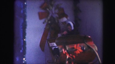 1958: a child on santa's lap in a christmas themed sleigh AMES, IOWA