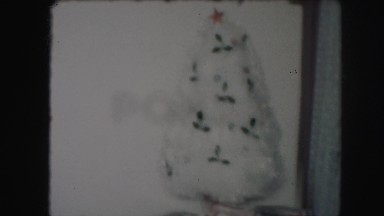 1958: a home around christmas time, with several decorations on its white walls.