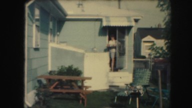1958: a woman is seen coming out of a house AMES, IOWA