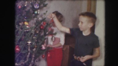 1958: a christmas tree is seen with people around AMES, IOWA