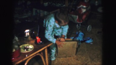 1958: very excited children are opening up gifts on christmas morning. AMES