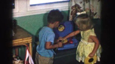1958: A Boy and Girl Operating a Cd Player in a Room in Ames, Iowa