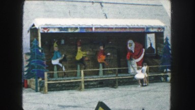 1958: santa claus and his three elves are working hard in the toy shop AMES