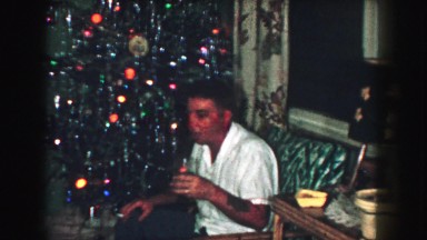 1958: a christmas tree is seen with a child opening presents AMES, IOWA