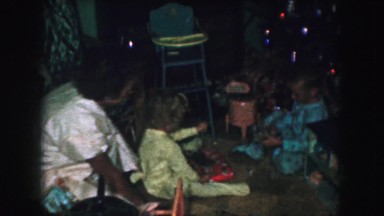 1958: a christmas tree is seen with a child opening presents AMES, IOWA