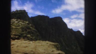 1958: driving fast on a hilly terrain with a scenic view of the world below