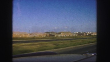 1958: watching outside of the window of moving car on highway
