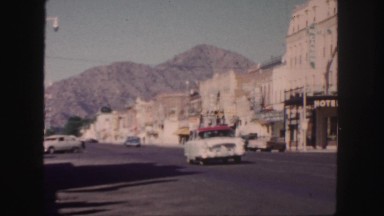 1958: cars passing by on a downtown street. COLORADO