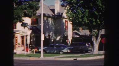 1958: cars parked in front of a house in a beautiful middle class neighborhood