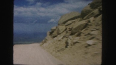 1958: a hilly area is seen with a car COLORADO
