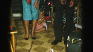 1958: happy couple playing with daughter's toys who looks unhappy AMES, IOWA
