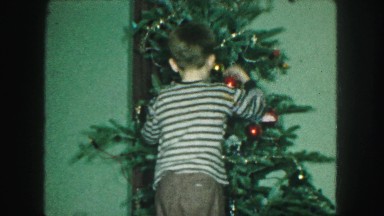 1958: boy decorating the christmas tree during the holidays AMES, IOWA