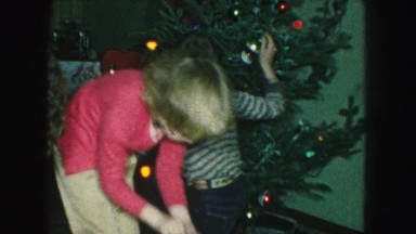 1958: brother and sister decorating the family christmas tree AMES, IOWA