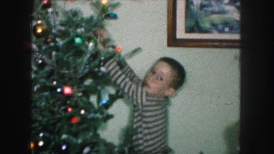 1958: brother and little sister decorating their christmas tree AMES, IOWA