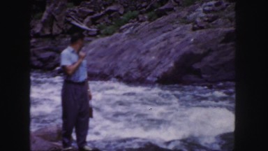 1958: a man standing along a powerful river sees something across the way