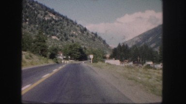 1958: a beautiful mountain ridge with pine trees as seen through the window