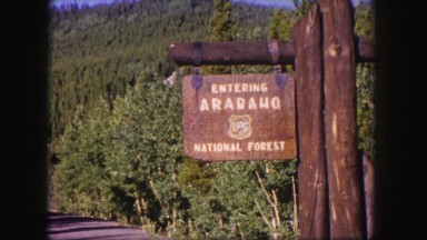 1958: rustic entrance sign for the beautiful arapaho national forest COLORADO