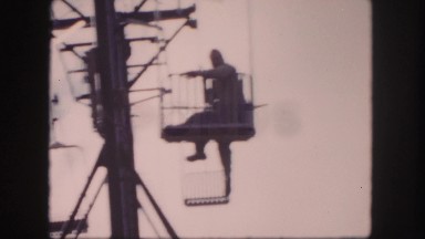 1958: a person is seen swinging on his hands in a net area COLORADO