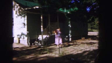 1958: ladie coming out her garage COLORADO