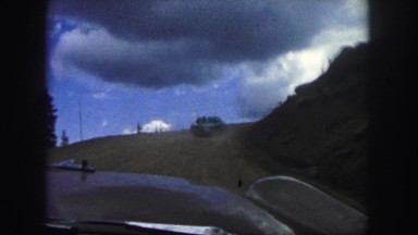 1958: a dangerous road on the side of a mountain as seen from a moving vehicle