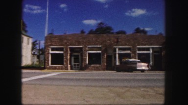 1958: mid 1900's car driving through middle of town on a hot summer day COLORADO