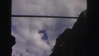 1958: looking at suspension bridge from bottom of ravine on a cloudy day