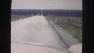 1958: a barren plane as seen through the window of a moving vehicle COLORADO