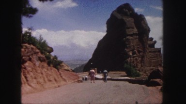 1958: two people people walking down a dirt road to an outdoor amphitheater