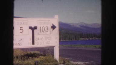 1958: a highway route marker set against a beautiful background of mountains