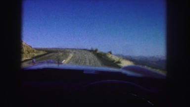1958: alone and quiet highway as a driver speeds onto its dangerous curves.