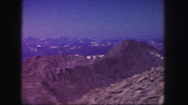 1958: a rugged outdoor scene with a hillside covered in beautiful trees